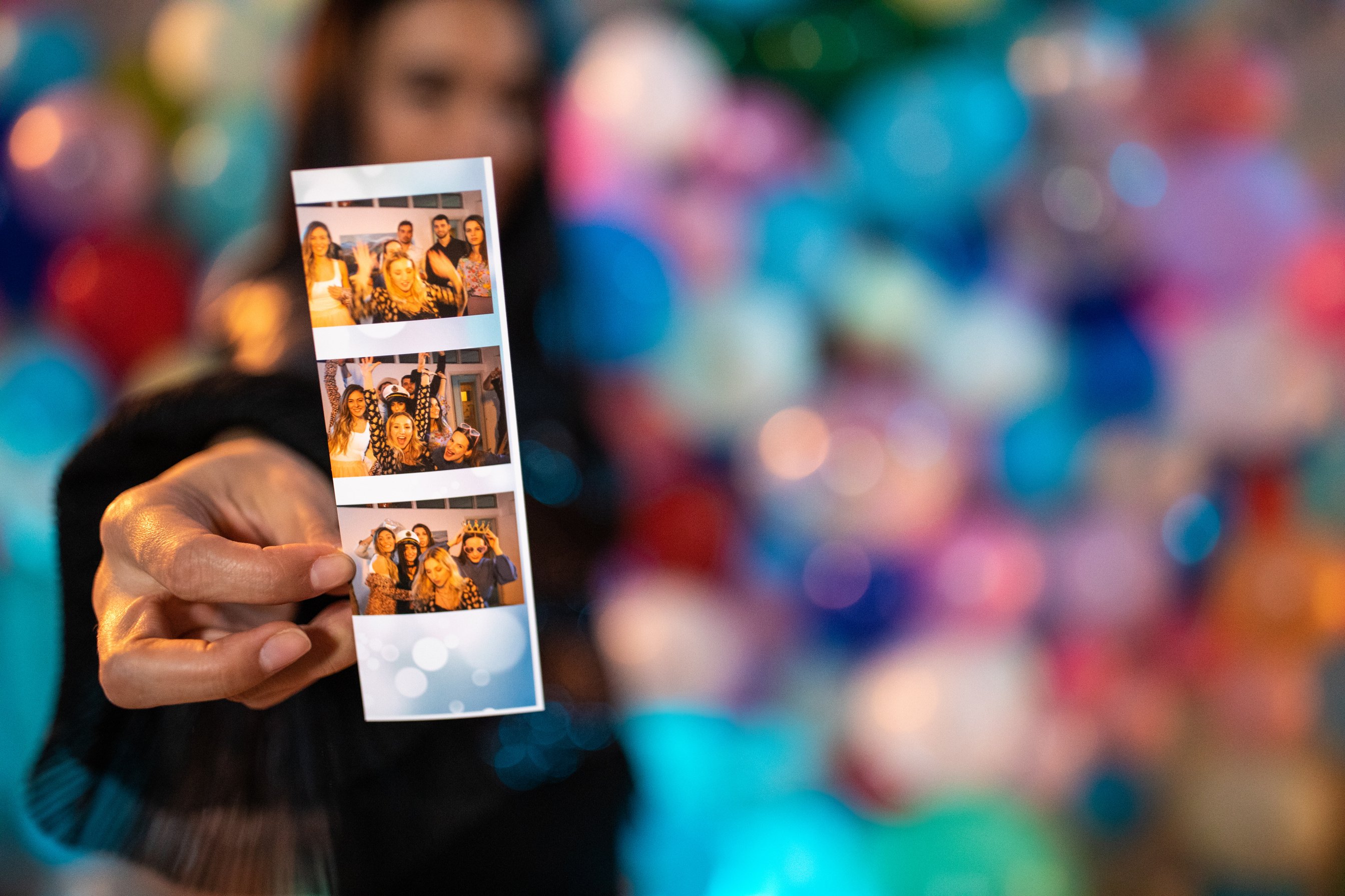 Photo booth picture in hands of unrecognizable woman