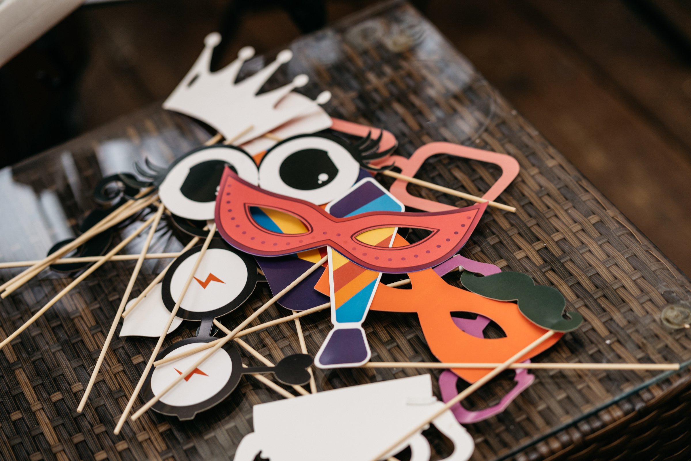 colorful photobooth props lying on a table